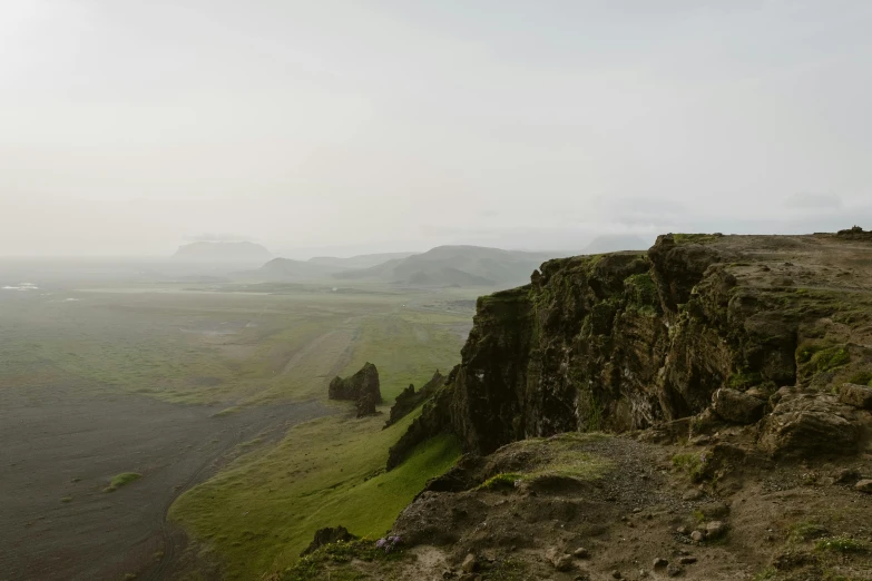 an area with high cliffs, a body of water and a few mountains