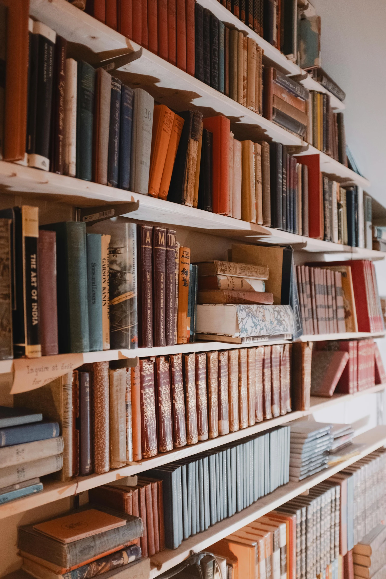 a collection of books on a white book shelf