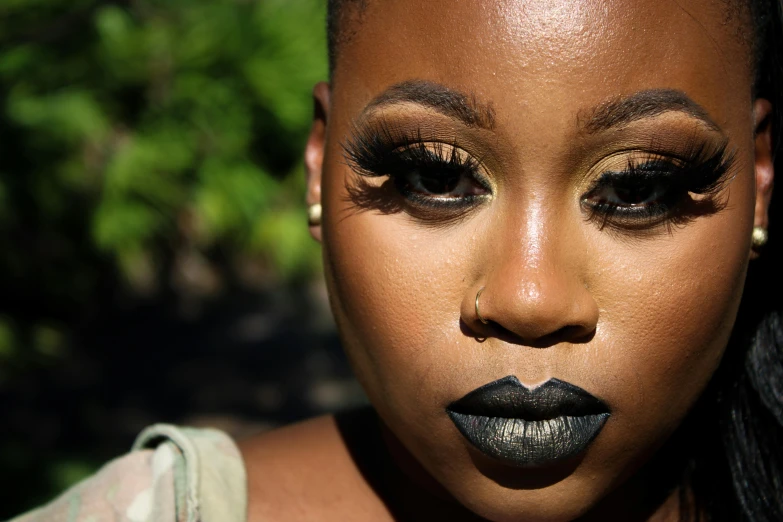 a woman with dark makeup and black lipstick