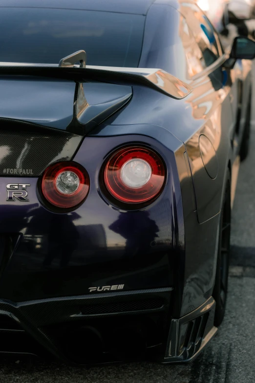 the rear end of a purple sports car parked on the side of the road