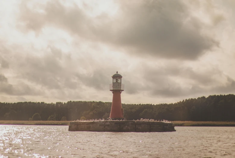 the light house is sitting in the water