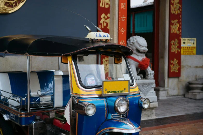 the small asian car is parked on the street