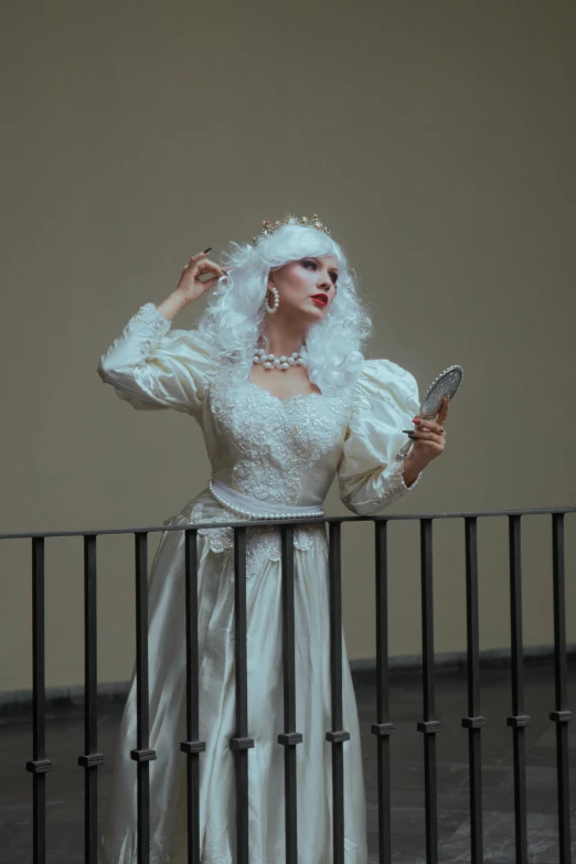 a woman wearing a white dress with long hair and a headpiece