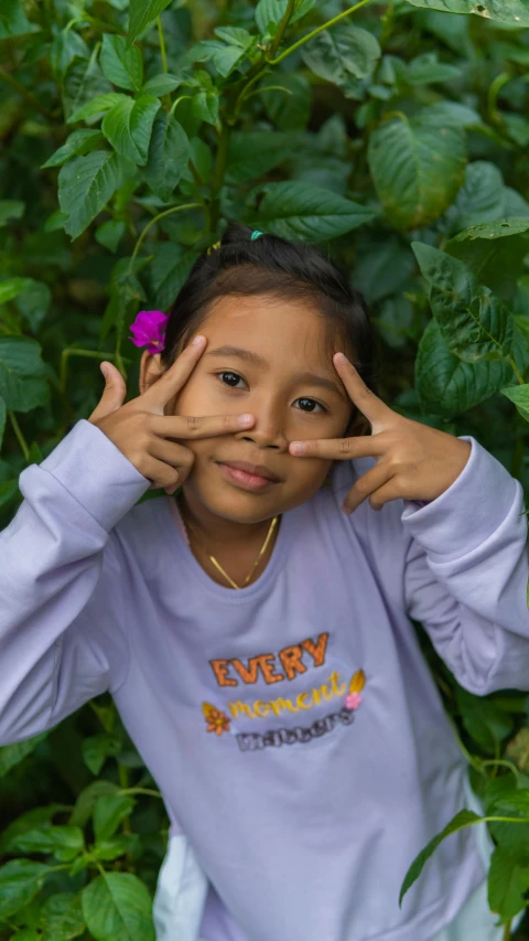 a  showing victory sign with her hands