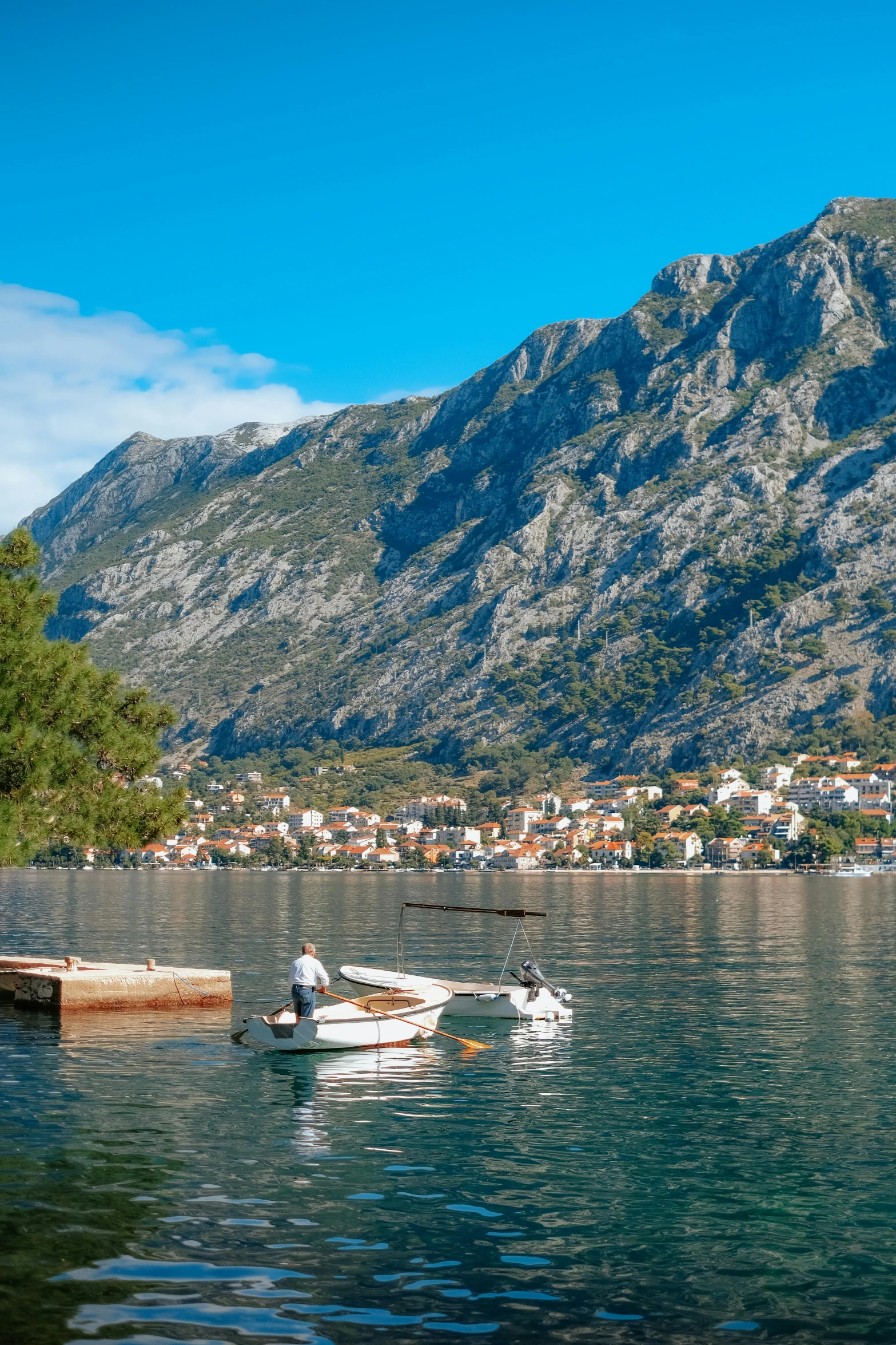 people are in the calm water next to boats