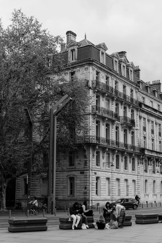 the front facade of a building with cars parked outside