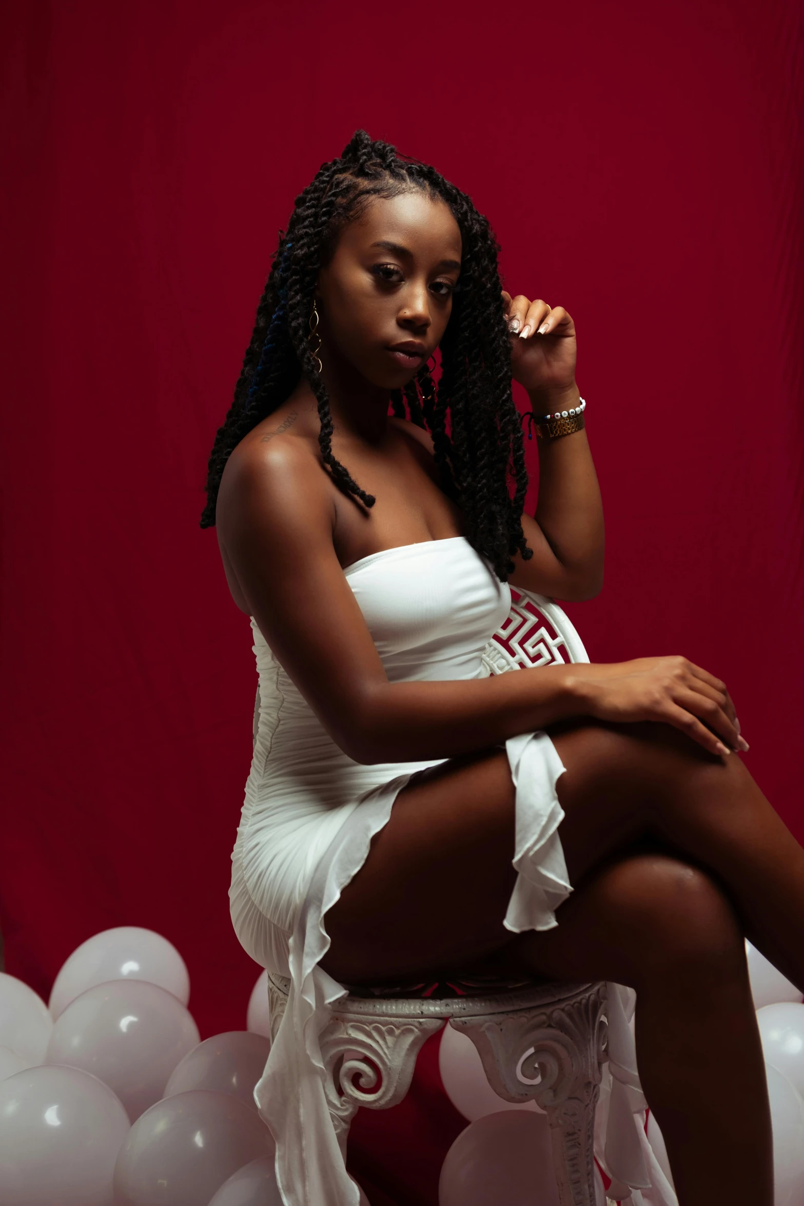 a woman is posing on some white balloons