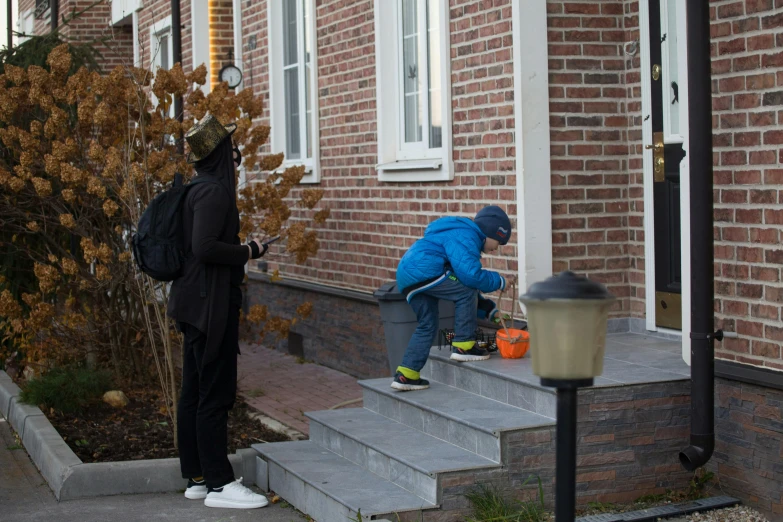 two people who are outside a house