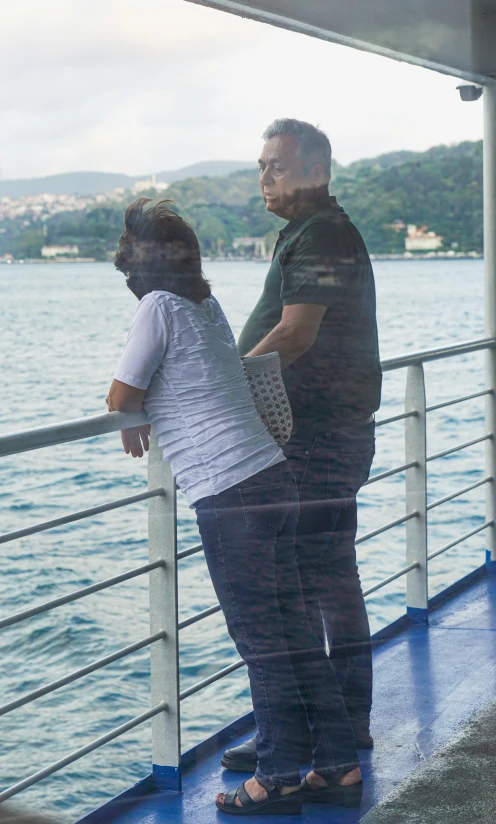 a couple standing on the deck of a cruise ship