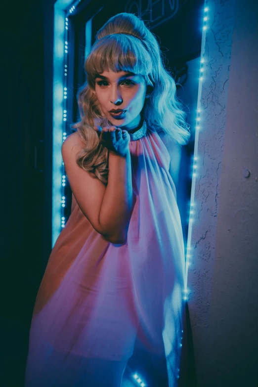 a young lady is posing for a pograph by the wall