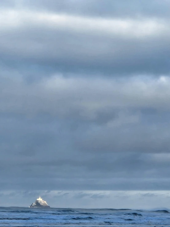 an airplane flying in the sky above a body of water