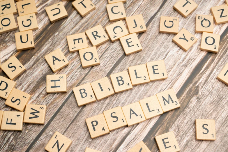 several scrabble tiles spelling words and symbols on a table