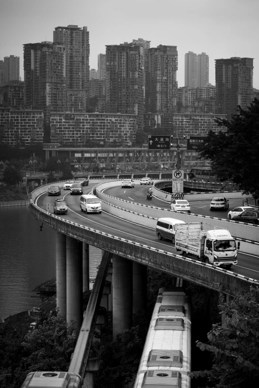 black and white pograph of a highway with cars on it