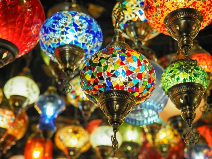 a display of many colorful glass and metal hanging lights