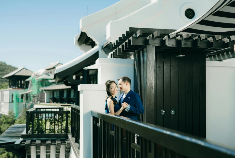 a couple emce and take a po in front of some buildings