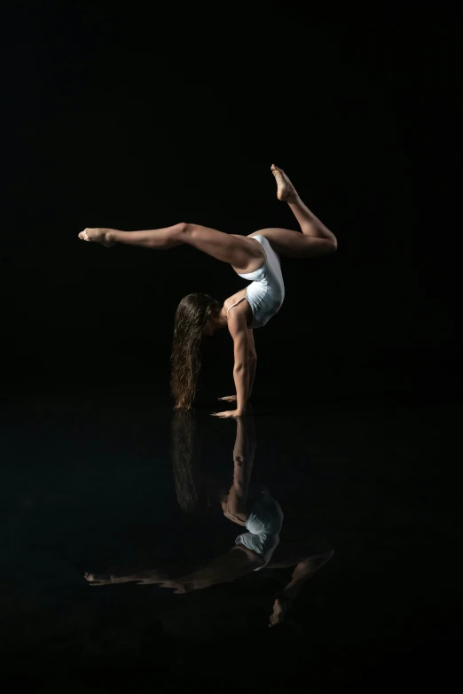 a person is doing a dance pose on the water