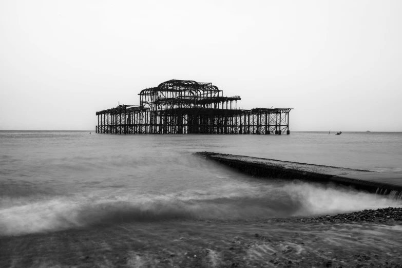 an abandoned building sitting in the middle of the ocean