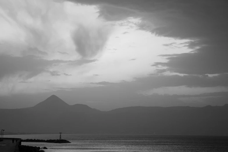 some clouds over some water and houses