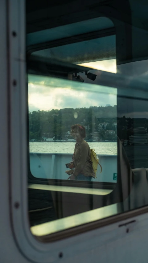 the reflection of a woman in a mirror on the back of a vehicle