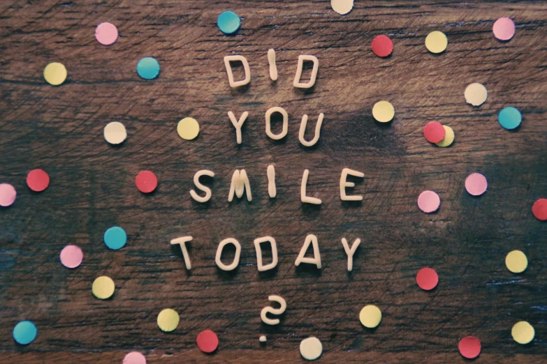 the words do you smile today written in wood letters