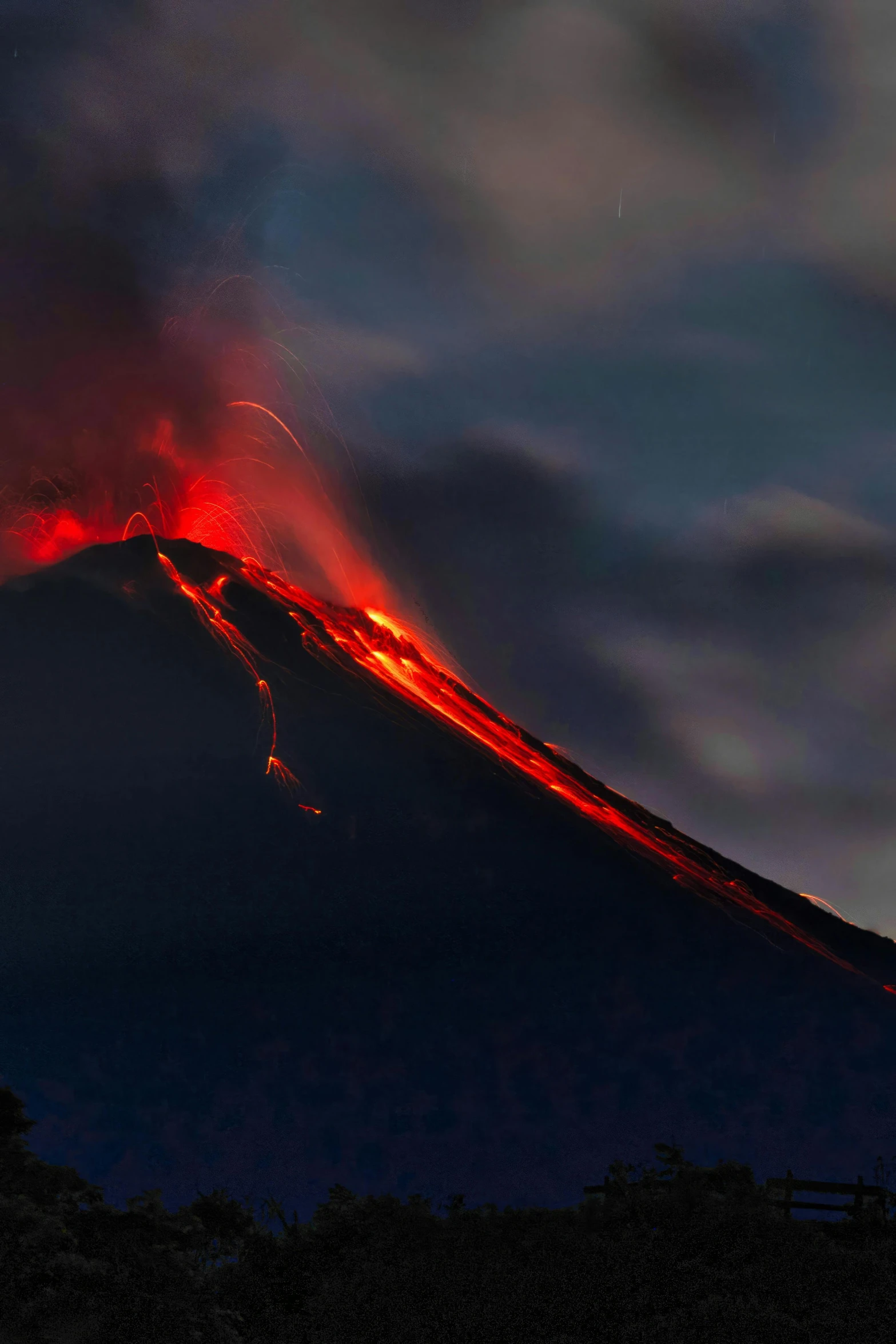 a volcano erupting red  lava while on top of a hill