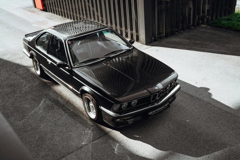 a mercedes - benz coupe parked on the side of the road