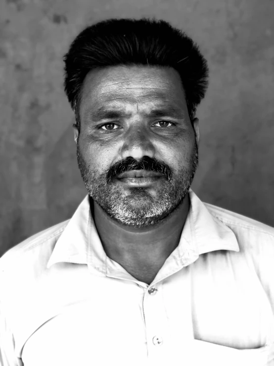 a close up of a man with short hair and beard