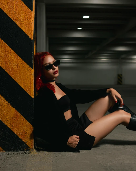 a woman is sitting on the floor with some kind of thigh high boots