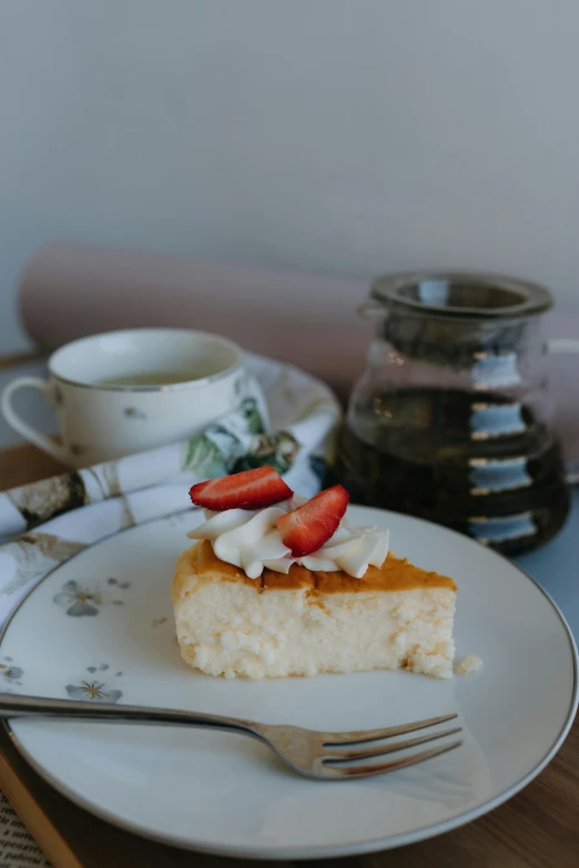 a slice of cake sitting on a white plate with some strawberries on top of it