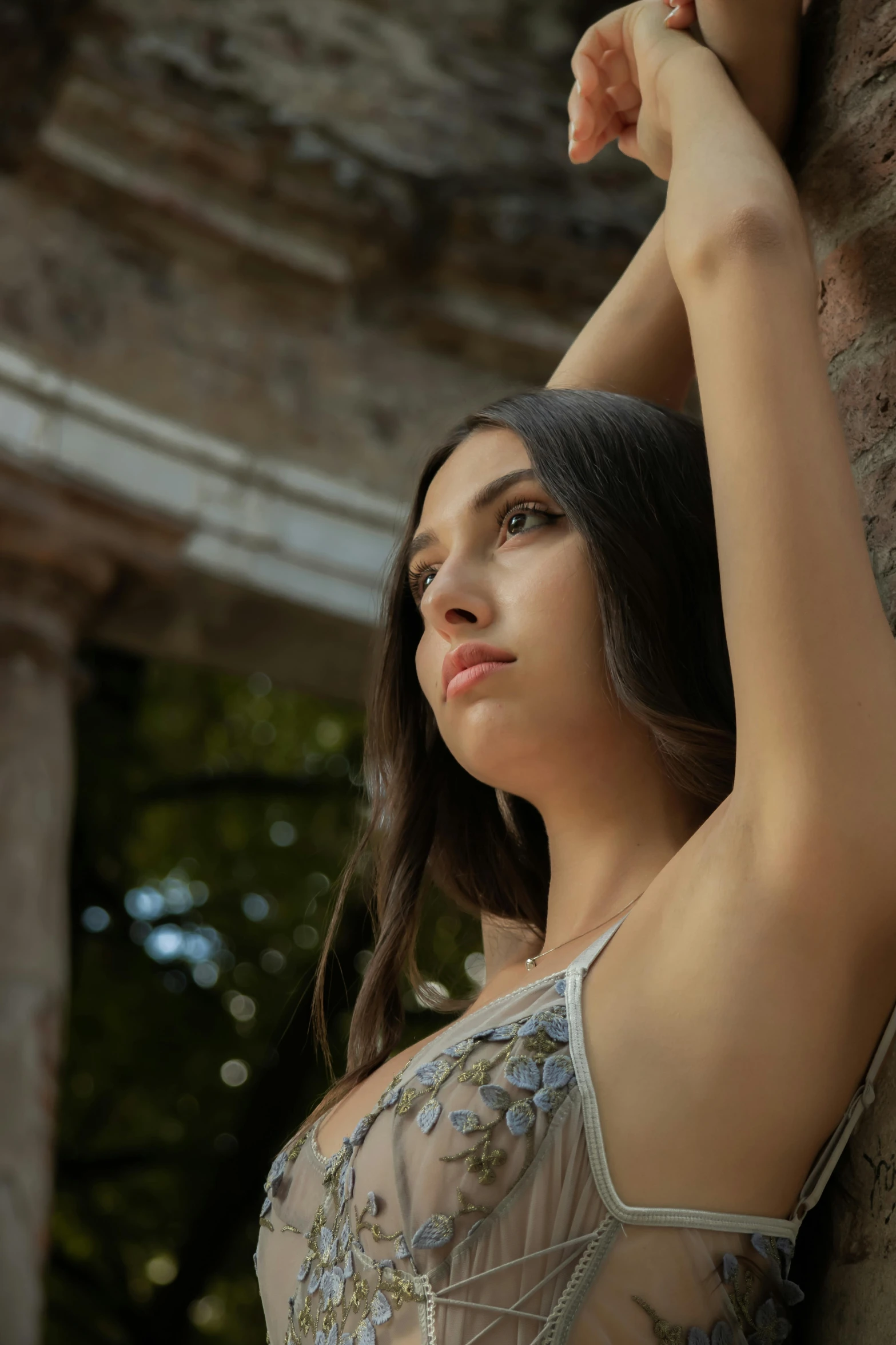 a beautiful young lady leaning on the wall