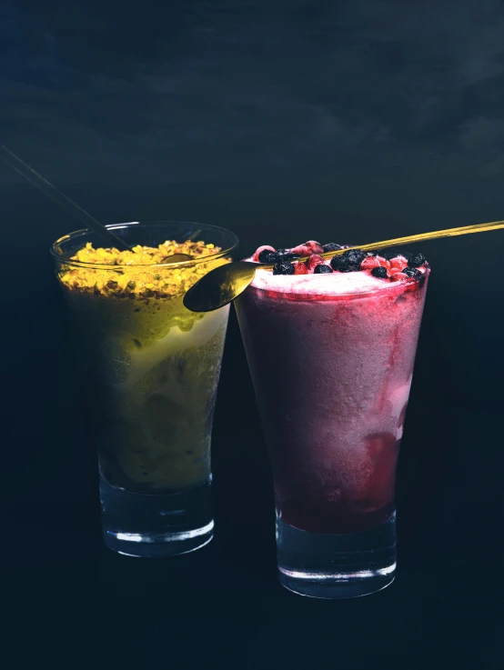 a glass with ice sits next to a cup of ice cream