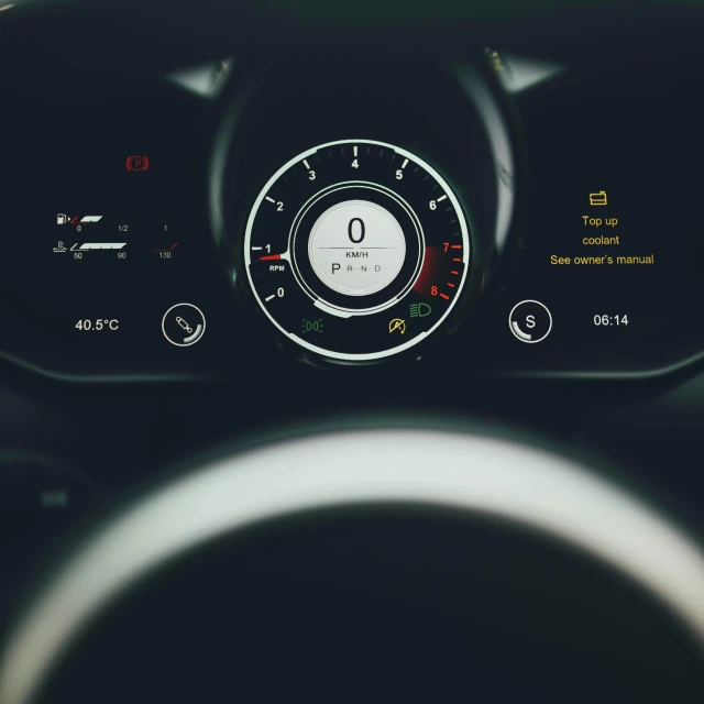 the dashboard of a car, with an analog display
