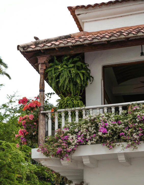 an open balcony with some flowers on it