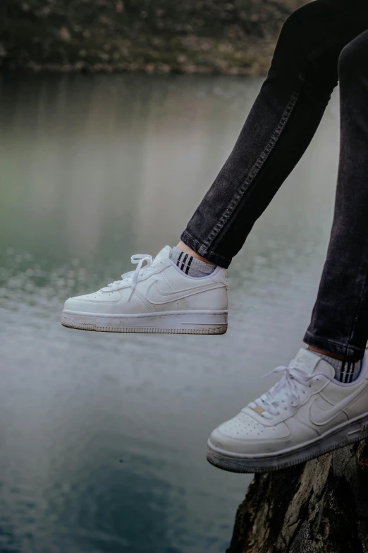 the shoes of someone who is walking on top of a tree