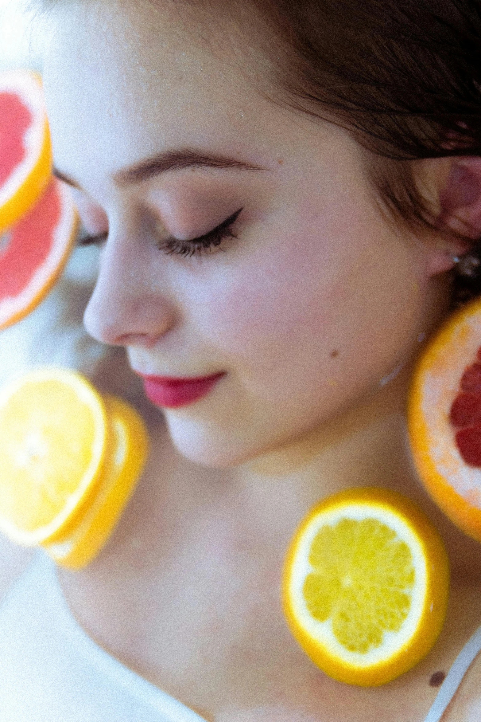 a woman wearing earring slices of fruit