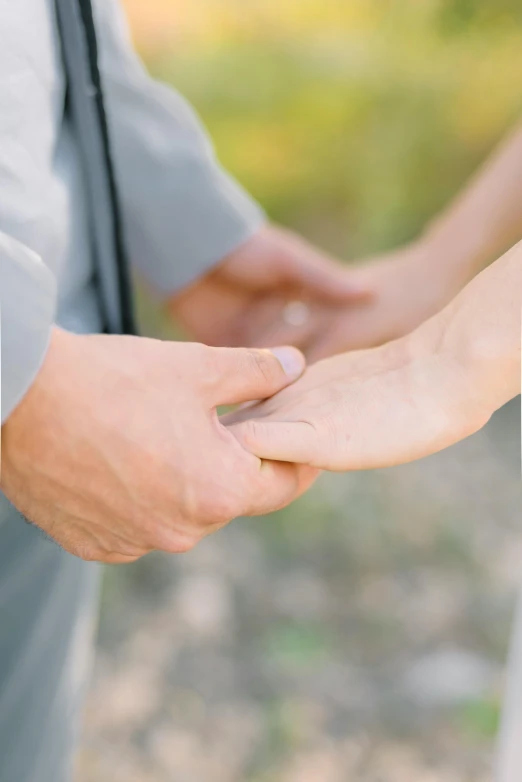 the two people holding hands are holding each other