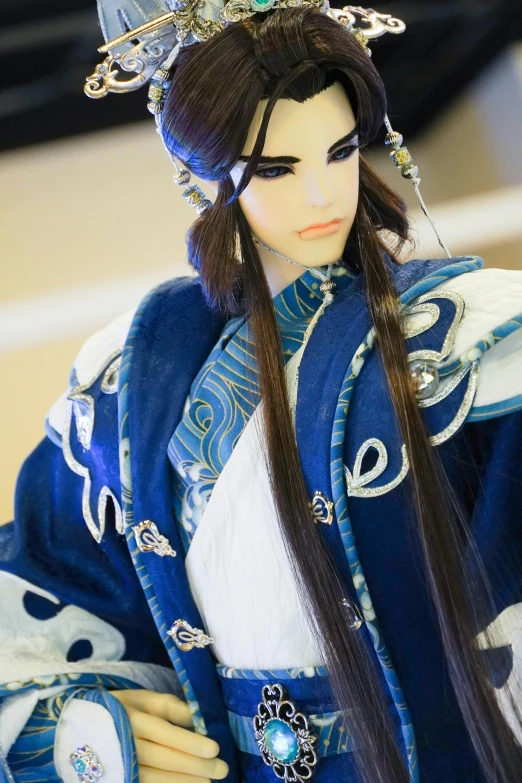 a close up of a doll dressed in a kimono