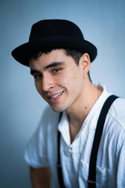 a man wearing an adjustable black hat smiling