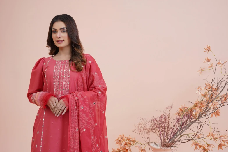 an indian lady poses in a red gown