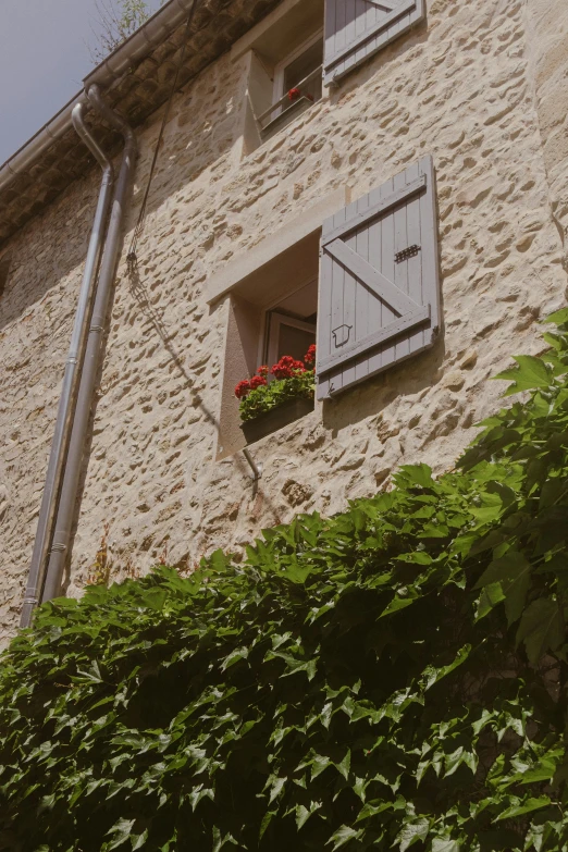 an old building with a window that is partially closed