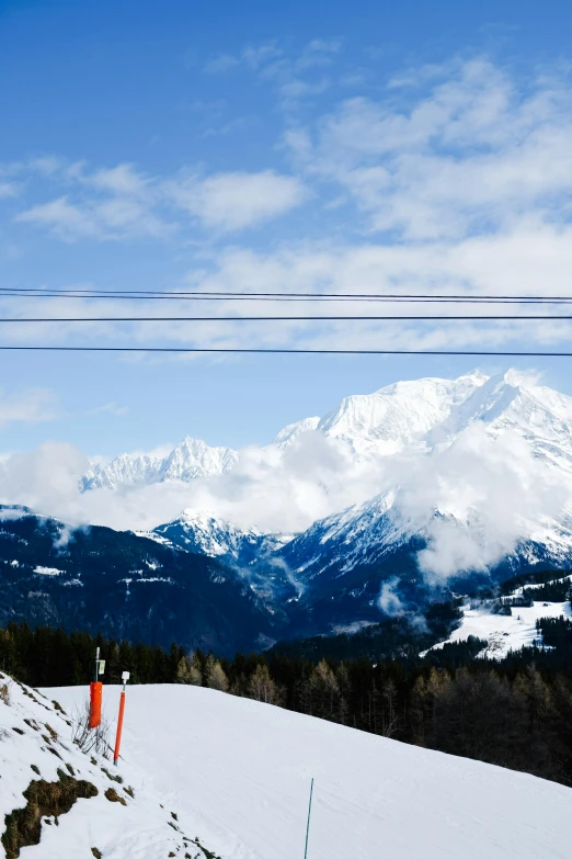 the snow skiers are at the top of the hill