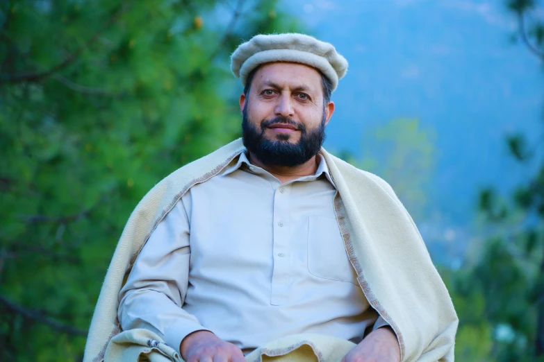 an image of a person sitting on a bench with trees in the background