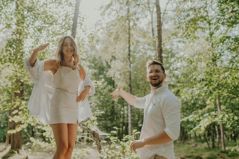 a couple having fun in the woods during their anniversary pos