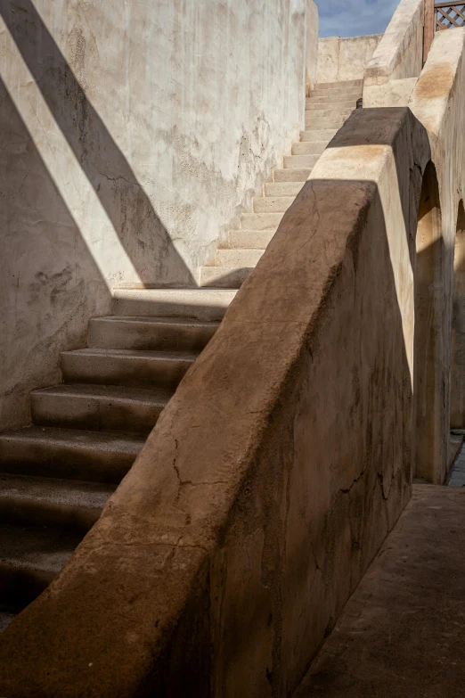 there is a brown stairway that leads up to the second floor