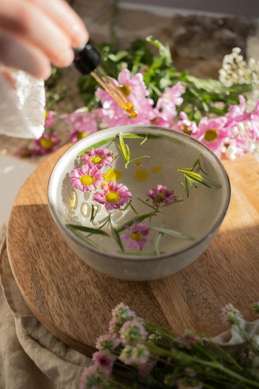 there is a flower that is being poured into a glass