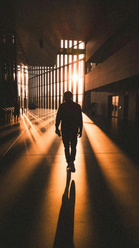 the silhouette of a person walking on a sidewalk