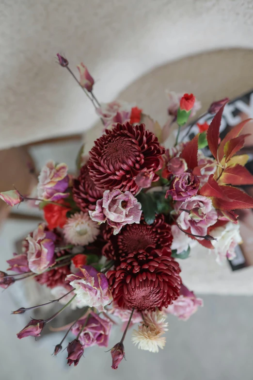 the brides bouquet has many large, red and white flowers