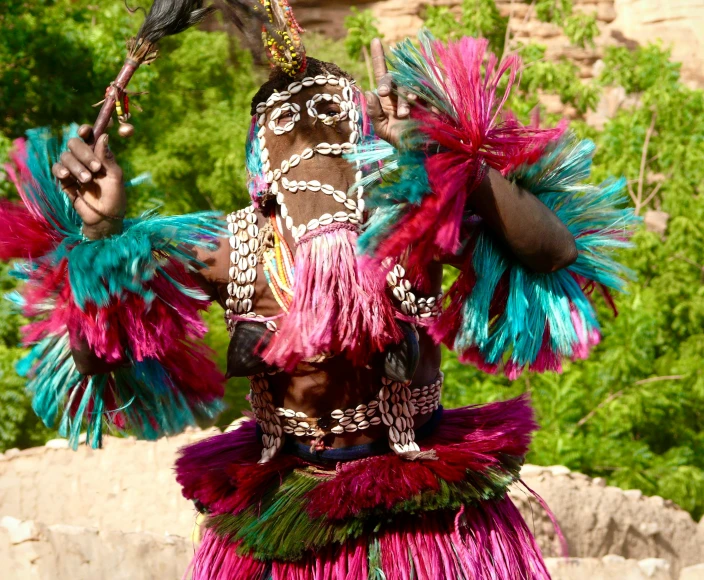 an indian style dancer performing with a bird on his head