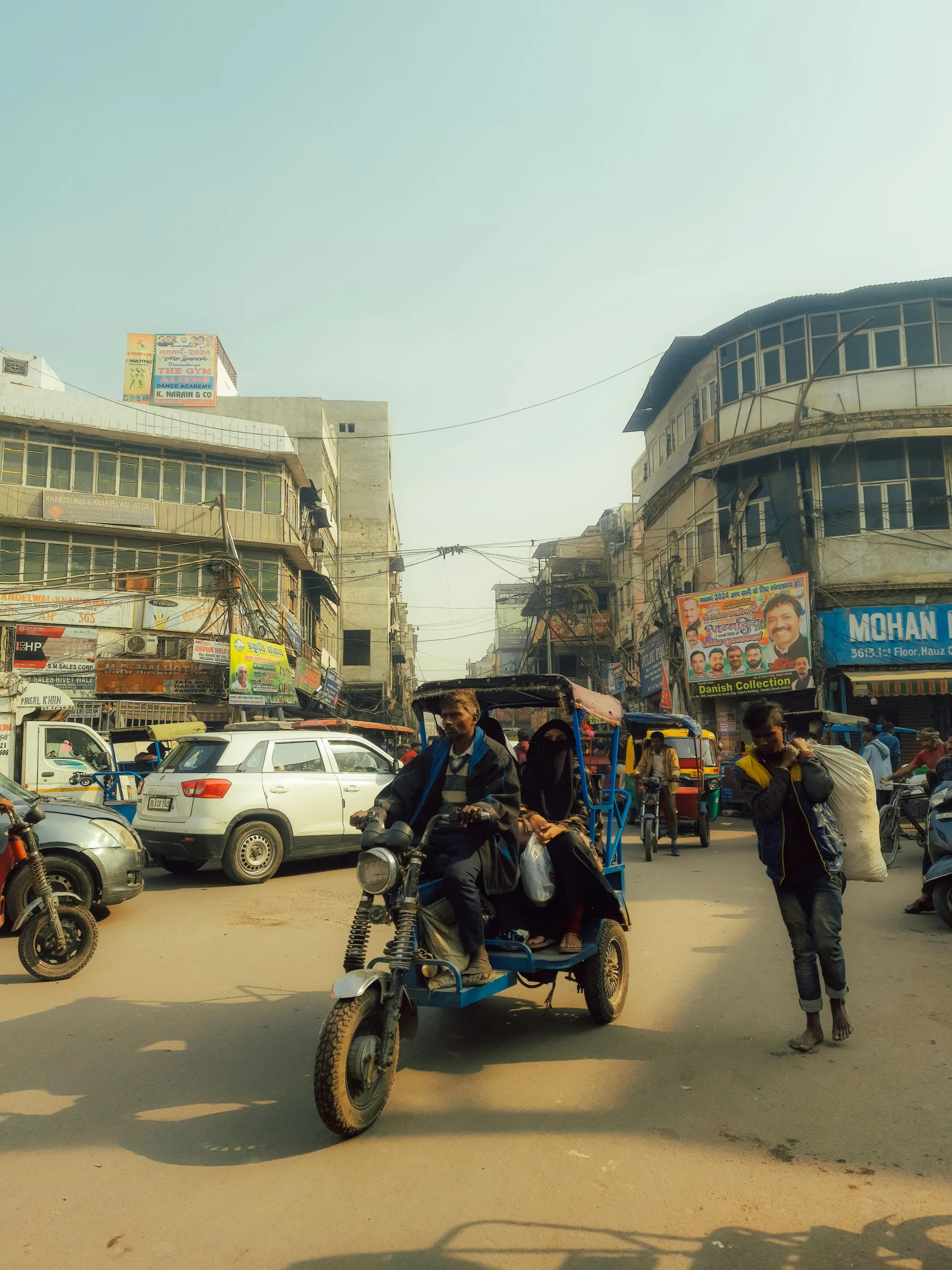 people ride an indian motorbike in the busy town