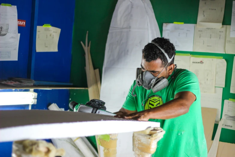 a man is standing next to a surfboard